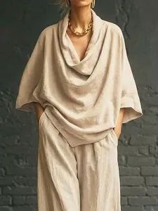 Closeup view of the elegant draped cowl neck top and wide leg pants in a smooth linen fabric.