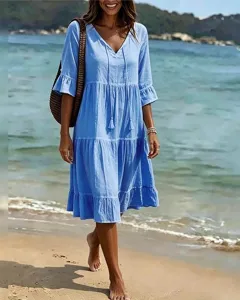 Light blue V-neck tiered midi dress with tassels for beach vacation and casual summer wear.