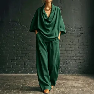Green cowl neck two-piece outfit detail, elegant wide-leg pants and loose top scene view.