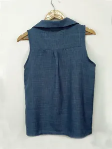 Detail view of back collar and sleeveless design of solid blue women vest top clean backdrop.