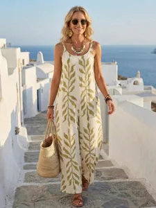 Women tropical leaf print casual jumpsuit detailed view in scenic outdoor setting, chic summer style.