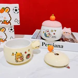 Close-up of cute cartoon ceramic mug with bear and rabbit design, orange lid and small spoon.