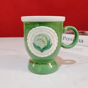 Vintage high-stem ceramic mug with lily of the valley relief, green coffee cup detail