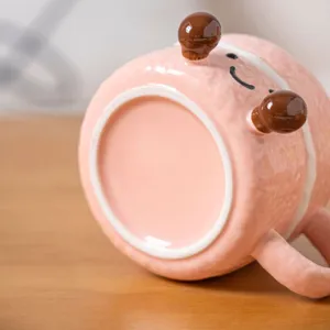 Cute ceramic mug with pink textured design, cartoon facial expression and sweet style for gift.
