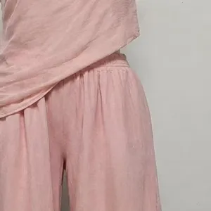 Pink linen-blend two-piece set detail, off-shoulder top and wide-leg trousers view.