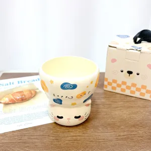 Detailed view of a cute ceramic cat cup with stacking design, perfect for coffee and tea.
