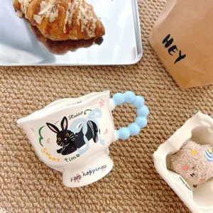 Creative ceramic mug with cute rabbit pattern and blue bubble handle, perfect for coffee or milk.