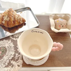 Ceramic coffee mug detail featuring cute bubble handle and interior text, lifestyle table setting.