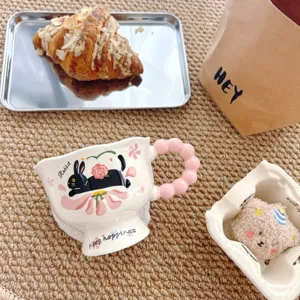 Cute ceramic mug with pink bubble handle, creative cartoon rabbit coffee milk cup for daily use.