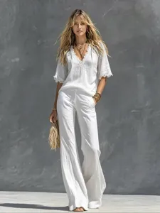 Detailed view of the white lace V-neck short sleeve top and matching wide leg pants set.