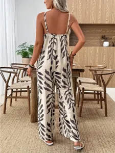 Tropical leaf print sleeveless jumpsuit back view detail in a cozy modern dining room setting