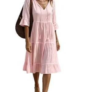 Womens pink V-neck tiered midi dress with ruffle sleeves and cute tassel ties for holiday.