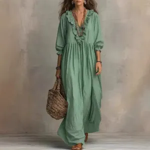 Green striped V-neck maxi dress with ruffles, long sleeves, and high waist design.