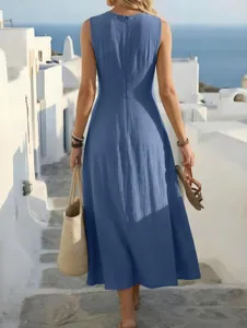 Back view of a blue sleeveless maxi dress showcasing resort lifestyle in scenic travel setting.