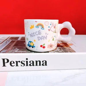Cute cartoon ceramic coffee mug with unique flower handle, detail view of cute printed cup.