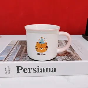 Ceramic mug detail shot featuring a cute cartoon tiger in a party hat and "HELLO" text.