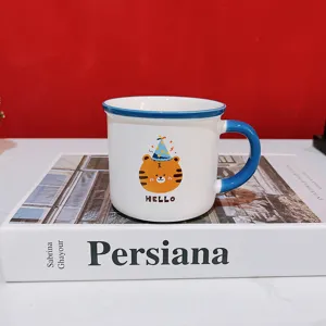 Detailed closeup view of ceramic coffee mug featuring cute cartoon tiger pattern and blue handle.