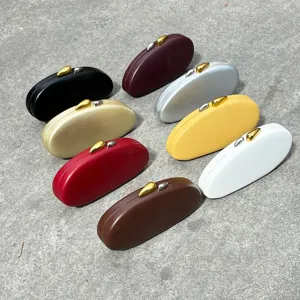 Closeup of colorful oval acrylic evening clutch bags, featuring stylish matte finish and metal clasps.