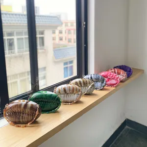 Gradient acrylic shell evening bag detail showing multiple vibrant color options neatly arranged.