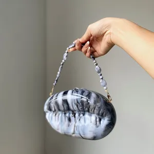 Details of the marble acrylic shell evening clutch bag with beaded handle, elegant and stylish.