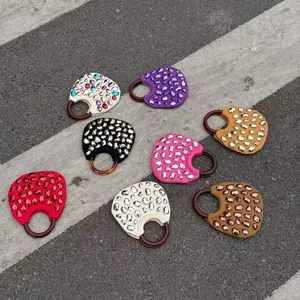 Colorful rhinestone handbag detail view showing vibrant color options and stylish ring handles.