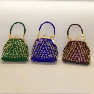 Sparkling rhinestone evening handbag with metallic kiss-lock closure and elegant top handle.