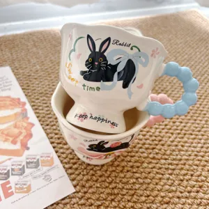 Creative cute ceramic coffee mug with black rabbit pattern and blue bead handle for daily use.