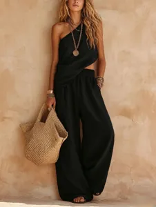 Detailed view of black one-shoulder two-piece set with wide-leg pants and linen fabric.