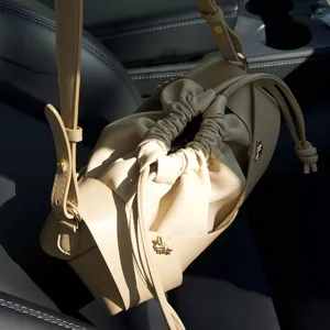 Vintage leather drawstring crossbody bag with crossed straps and soft pleated niche design bucket bag.
