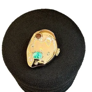 Metallic acrylic evening bag with irregular shape and stone inlay for women's fashion styling.