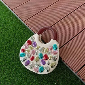 Colorful metallic pebble embellished canvas handbag featuring a chic circular brown handle design.