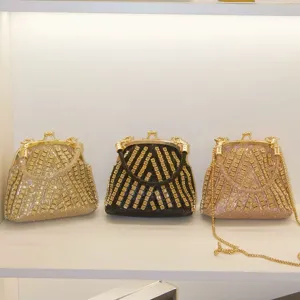 Detailed view of luxury rhinestone evening bags featuring sparkling crystals and metal kiss-locks.
