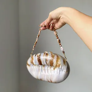 Acrylic shell evening bag with beaded handle, elegant clutch for party and wedding events.
