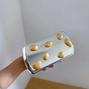 Metallic-silberne Clutch mit goldenen Kieselsteinen, modernes Design für Abendpartys.