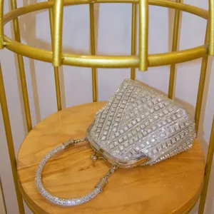 Exquisite rhinestone evening clutch bag with metal clasp and sparkling crystal handle details.