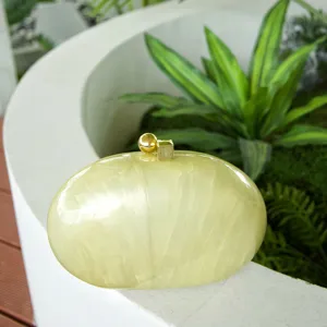 Acrylic marble pattern oval clutch bag detail, elegant green shell box bag with gold clasp.