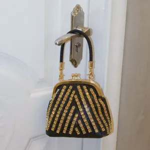 Black and gold rhinestone evening bag, luxury crystal clutch purse with metallic frame for women.