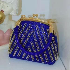 Exquisite blue rhinestone evening clutch bag featuring gold hardware and crystal sparkle.