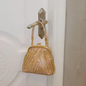 Rhinestone evening bag detail, sparkling crystal clutch purse, elegant gold metal frame design.