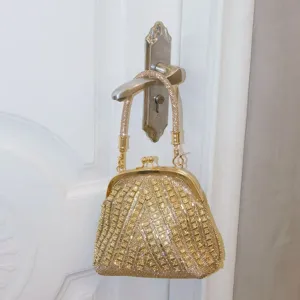 Gold rhinestone evening bag with kissing lock and crystal handle, elegant accessory for party.