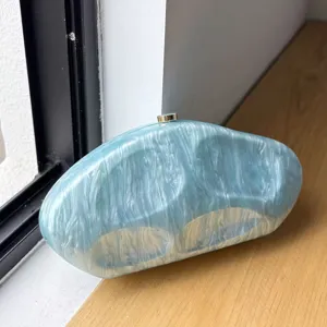 Stunning irregular marble acrylic evening clutch bag, elegant blue statement accessory for parties.
