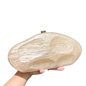 Stylish irregular acrylic evening clutch bag for women, elegant marbled pattern design for party.