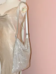 Silver rhinestone slouchy shoulder bag detail view, sparkling crystal hobo handbag design.