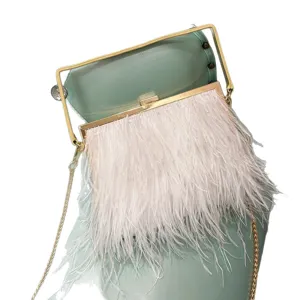 Elegant feather clutch bag with gold frame and chain strap, perfect for evening parties.