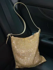 Sparkling rhinestone shoulder bag closeup, luxury sparkling crystal underarm crossbody bag design.