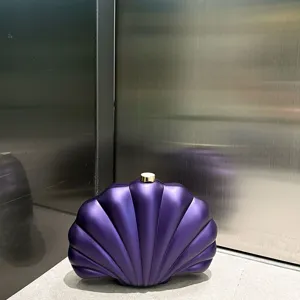 Matte purple acrylic shell clutch bag detail, stylish evening purse with gold lock.