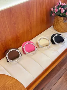Exquisite evening handbag featuring a sparkling rhinestone circular handle, elegant and chic.