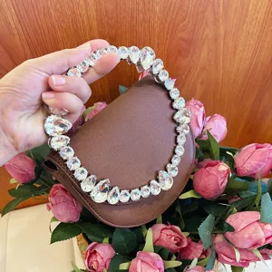 Crystal handle brown evening handbag detail shot, elegant rhinestone clutch for women parties.