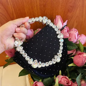 Black velvet evening bag with sparkling crystal handle and rhinestone accents for women parties.