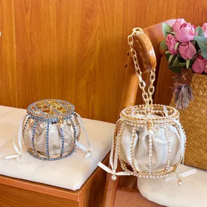 Elegant rhinestone cage bucket bag with velvet inner pouch and luxury metal chain handle for evening.